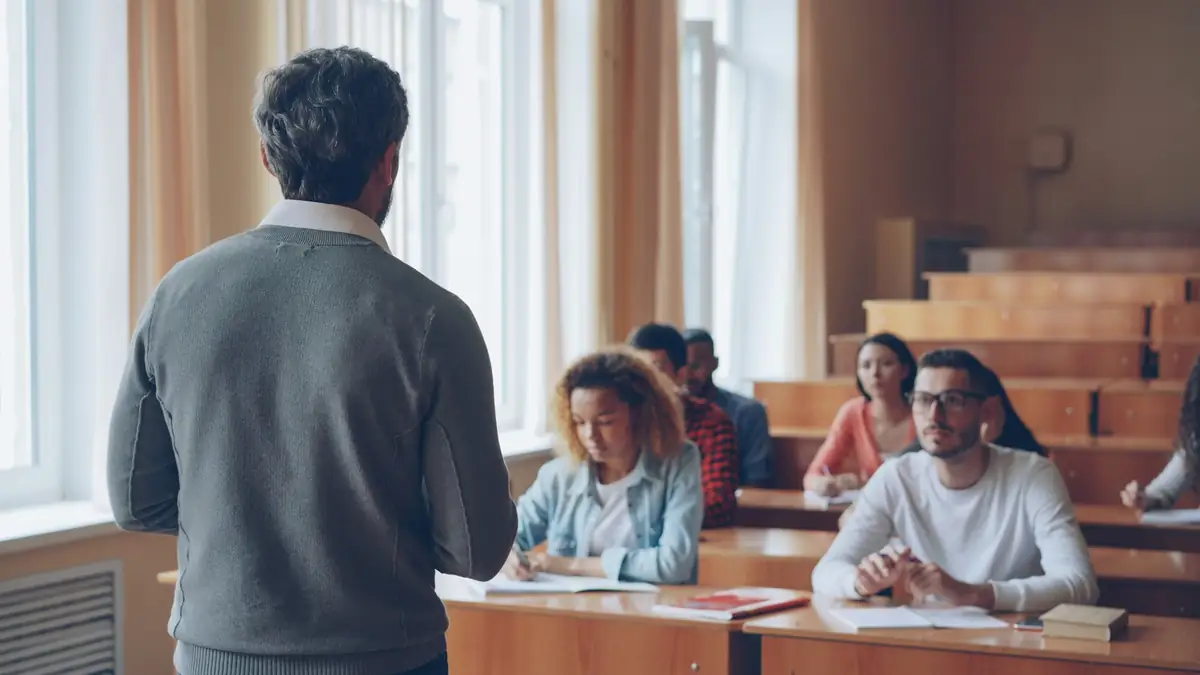 A lecturer teaching a class of students